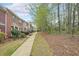 Traditional brick townhome exteriors showcase well-manicured lawns, sidewalks, and lush landscaping in a peaceful neighborhood at 3729 Town Square Nw Cir # 6, Kennesaw, GA 30144