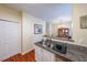 Galley kitchen featuring granite countertops and view into the dining area at 3729 Town Square Nw Cir # 6, Kennesaw, GA 30144