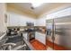 Well-equipped kitchen featuring stainless appliances, granite counters, and white cabinets at 3729 Town Square Nw Cir # 6, Kennesaw, GA 30144