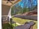 Inviting covered patio with outdoor seating, overlooking a well-maintained lawn and landscaped backyard at 724 Fairlane Dr, Marietta, GA 30064