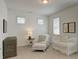 Bedroom room with a crib, decorative chair and side table, and window with blinds at 724 Fairlane Dr, Marietta, GA 30064