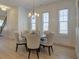 Elegant dining room with a round table, six upholstered chairs, and natural light from large windows at 724 Fairlane Dr, Marietta, GA 30064