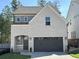 Charming two-story home with brick facade, gray accents, a two-car garage and well-maintained landscaping at 724 Fairlane Dr, Marietta, GA 30064