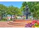 Elegant tiered fountain in a town square, surrounded by brick steps, benches and landscaping at 724 Fairlane Dr, Marietta, GA 30064