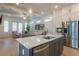 Open-concept kitchen with hardwood floors, a large island, stainless steel appliances, and modern lighting at 724 Fairlane Dr, Marietta, GA 30064