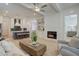 Open-concept living room with a fireplace, hardwood floors, and a view into the modern kitchen at 724 Fairlane Dr, Marietta, GA 30064