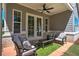 Comfortable covered patio featuring outdoor furniture and a ceiling fan for relaxed outdoor living at 724 Fairlane Dr, Marietta, GA 30064