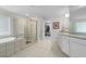 Bright bathroom featuring a soaking tub, glass shower, double vanity and walk-in closet at 3087 Mountain Shadow Way, Marietta, GA 30064