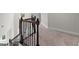 Upstairs hallway featuring hardwood railings, black metal spindles and neutral walls and carpet at 3087 Mountain Shadow Way, Marietta, GA 30064