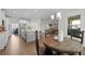 Open-concept kitchen and dining area with a large island, stainless appliances, and hardwood floors at 3087 Mountain Shadow Way, Marietta, GA 30064