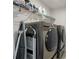 Modern laundry room with gray washer and dryer units and ample storage at 3087 Mountain Shadow Way, Marietta, GA 30064