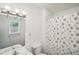 A clean bathroom with a shower, vanity, toilet, mirror and window offering a serene and functional space at 3980 Carlton Cove Ct, Loganville, GA 30052