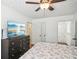 A spacious bedroom with a ceiling fan, dresser, and open doorway to the bathroom at 3980 Carlton Cove Ct, Loganville, GA 30052