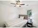 A cozy bedroom featuring a ceiling fan, natural light and a calming atmosphere, perfect for relaxation at 3980 Carlton Cove Ct, Loganville, GA 30052