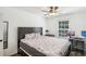 A modern bedroom featuring a ceiling fan, computer desk setup, mirror and ample space for personalization at 3980 Carlton Cove Ct, Loganville, GA 30052
