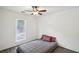 A serene bedroom showcasing a ceiling fan, modern flooring, and a window for natural light, enhancing the room's appeal at 3980 Carlton Cove Ct, Loganville, GA 30052