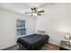A calming bedroom with a ceiling fan and window, showcasing a harmonious blend of natural light and soothing ambiance at 3980 Carlton Cove Ct, Loganville, GA 30052