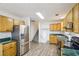 Efficient kitchen with stainless steel refrigerator, wood cabinets, and laminate countertop offers a great space at 3980 Carlton Cove Ct, Loganville, GA 30052