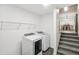 Bright laundry room with modern washer and dryer, and convenient shelving, perfect for efficient home management at 3980 Carlton Cove Ct, Loganville, GA 30052