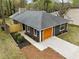 Aerial view showcasing the property's layout and an orange garage door, and landscaping at 4540 Bryant Rd, Buford, GA 30518