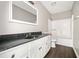 Well lit bathroom featuring a white vanity and speckled black countertop, plus shower and toilet at 4540 Bryant Rd, Buford, GA 30518