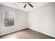 This bedroom offers ample natural light from the window and wood flooring at 4540 Bryant Rd, Buford, GA 30518