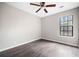 Bright bedroom with wood floors, ceiling fan and window with wooden blinds at 4540 Bryant Rd, Buford, GA 30518