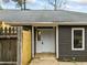 View of the home's entrance, with a white front door, framed by fresh white trim at 4540 Bryant Rd, Buford, GA 30518