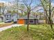 View of the house displaying an orange garage door, complementing the exterior, and landscaping at 4540 Bryant Rd, Buford, GA 30518