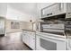 Open concept kitchen with modern appliances, granite countertops, and a view into the dining area at 4540 Bryant Rd, Buford, GA 30518