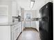 Modern kitchen featuring white cabinets, stainless steel appliances, and granite countertops at 4540 Bryant Rd, Buford, GA 30518