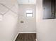 Small laundry room with wood-look floors, a wire shelf, window, and washer/dryer hookups at 4540 Bryant Rd, Buford, GA 30518