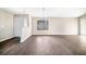 Spacious living room with wood-look flooring, a large window, and a view of the front door and entryway at 4540 Bryant Rd, Buford, GA 30518
