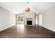 Open-concept living room featuring wood-look flooring, a stone fireplace, vaulted ceilings, and backyard access at 4540 Bryant Rd, Buford, GA 30518