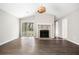 Bright living room with wood-look floors, vaulted ceilings, a stone fireplace, and access to the backyard at 4540 Bryant Rd, Buford, GA 30518