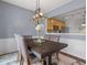 Bright dining room with a dark wood table, stylish chairs, and open view to kitchen at 1680 Fair Oak Way # 24, Mableton, GA 30126