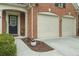 Close-up of brick home exterior with two-car garage and covered front entrance at 1680 Fair Oak Way # 24, Mableton, GA 30126