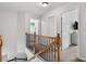 Upstairs hallway featuring wood and iron railings and a view to the laundry room and bedroom at 1680 Fair Oak Way # 24, Mableton, GA 30126