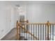 Bright hallway with a staircase featuring a wooden railing and black iron balusters at 1680 Fair Oak Way # 24, Mableton, GA 30126
