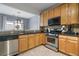 Traditional kitchen featuring wooden cabinets, stainless steel appliances, and a view to the exterior at 1680 Fair Oak Way # 24, Mableton, GA 30126
