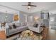 Open concept living room with hardwood floors, large sofa, and view of dining area at 1680 Fair Oak Way # 24, Mableton, GA 30126