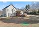 View of the home's rear elevation showing the outdoor deck, large backyard, and well-maintained lawn at 2230 Mcbrayer Ct, Cumming, GA 30028
