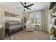 Well-lit Bedroom with black metal crib, accent wall and ceiling fan at 2230 Mcbrayer Ct, Cumming, GA 30028