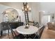 Dining area featuring stylish lighting, a statement mirror, and convenient access to living spaces at 2230 Mcbrayer Ct, Cumming, GA 30028