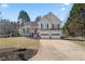 Charming two-story home features a well-maintained lawn and an attached two-car garage at 2230 Mcbrayer Ct, Cumming, GA 30028