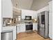 Bright, modern kitchen with white cabinets, stainless steel appliances, and sleek countertops at 2230 Mcbrayer Ct, Cumming, GA 30028