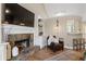 Comfortable living room with a stone fireplace, built-in shelving, and view of the breakfast bar at 2230 Mcbrayer Ct, Cumming, GA 30028