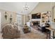 Inviting living room with a stone fireplace, modern lighting, and comfortable seating arrangement at 2230 Mcbrayer Ct, Cumming, GA 30028