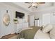 Spacious main bedroom with ensuite bath, dresser, and ceiling fan at 2230 Mcbrayer Ct, Cumming, GA 30028