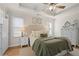 Bright main bedroom features tray ceiling, ceiling fan, and a neutral color palette at 2230 Mcbrayer Ct, Cumming, GA 30028